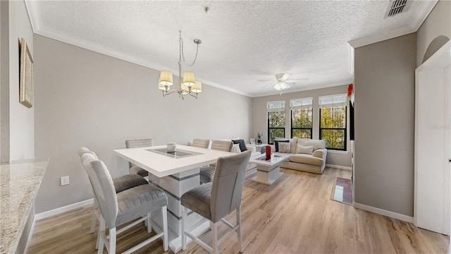 2717 Via Cipriani Unit 622B, Clearwater, FL 33764 - dining space with a ceiling fan, light wood-style floors, ornamental molding, a chandelier, and baseboards