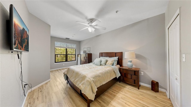 bedroom with a closet, ceiling fan, and light hardwood / wood-style floors