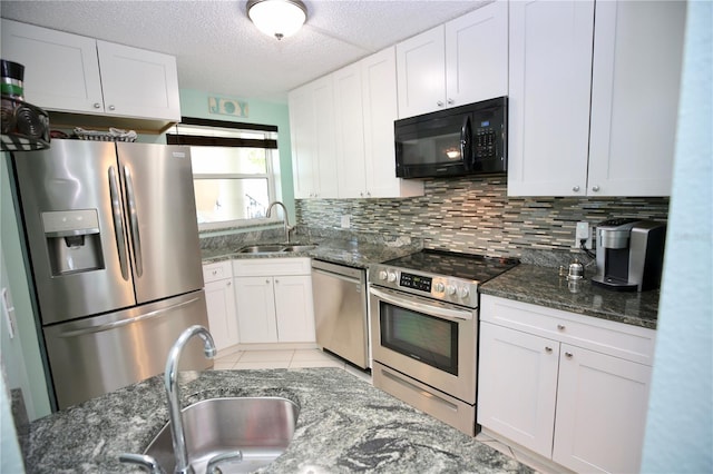 1901 Oyster Catcher Ln Unit 814, Clearwater, FL 33762 - kitchen with white cabinets, a sink, backsplash, and appliances with stainless steel finishes