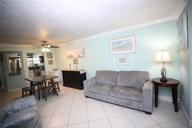 tiled living room featuring ornamental molding, sink, and ceiling fan