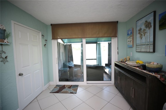 interior space with vanity, a textured ceiling, and tile patterned flooring