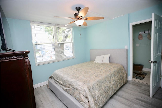 bedroom with light hardwood / wood-style floors and ceiling fan