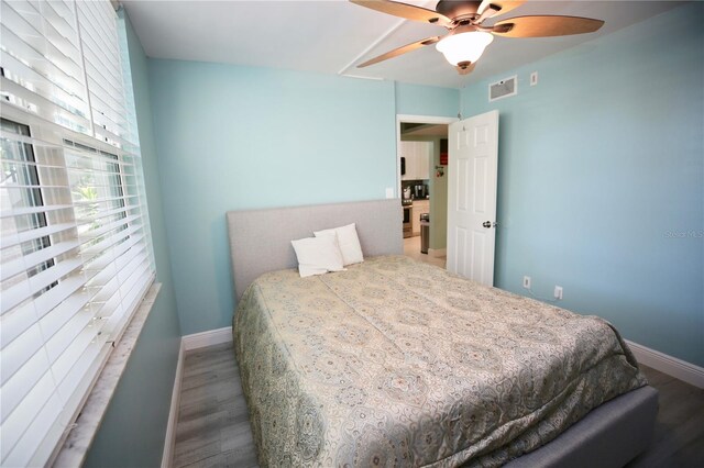 bedroom with hardwood / wood-style floors and ceiling fan