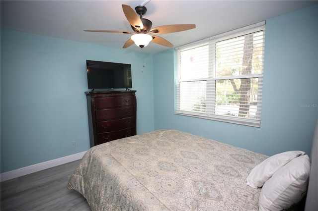 bedroom with ceiling fan and hardwood / wood-style flooring