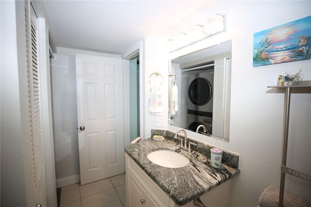 bathroom featuring vanity, tile patterned floors, and stacked washer / dryer