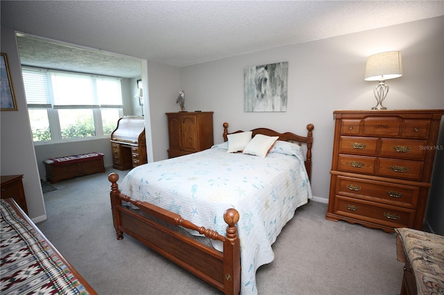 carpeted bedroom featuring a textured ceiling