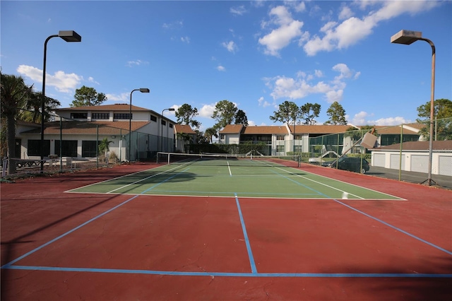 view of tennis court with basketball hoop