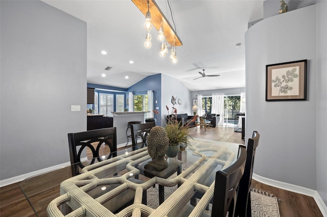 dining space featuring lofted ceiling, dark hardwood / wood-style floors, and plenty of natural light