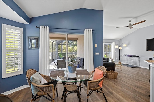 dining area featuring vaulted ceiling, wood-type flooring, and plenty of natural light