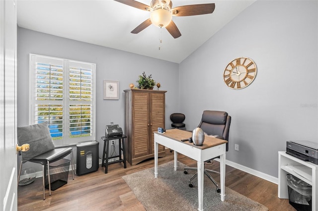 office space with ceiling fan, hardwood / wood-style flooring, and vaulted ceiling