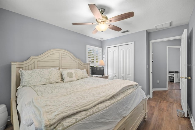 bedroom with a closet, ceiling fan, and dark wood-type flooring