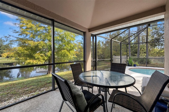 sunroom with a water view and vaulted ceiling