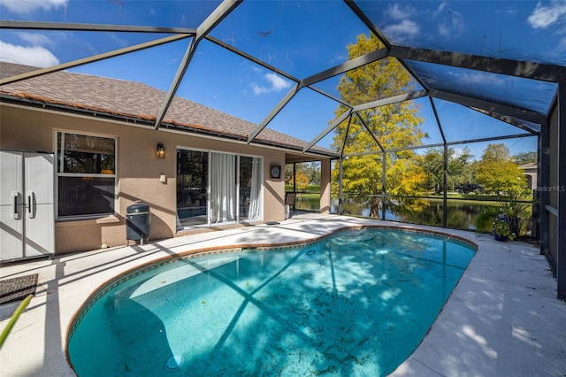 view of swimming pool with a patio area, a lanai, and a water view