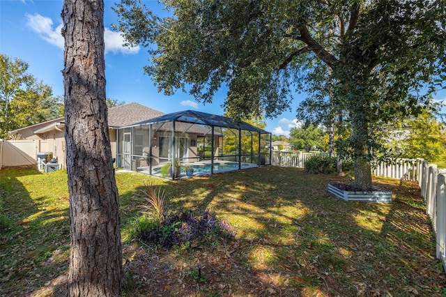 view of yard with a fenced in pool and a lanai