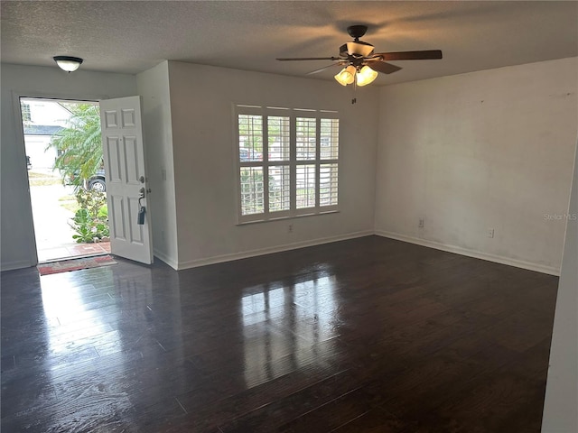 interior space with ceiling fan, dark hardwood / wood-style floors, and a textured ceiling