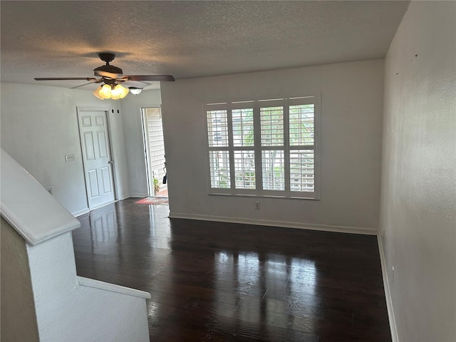 unfurnished living room featuring ceiling fan, dark hardwood / wood-style floors, and a textured ceiling