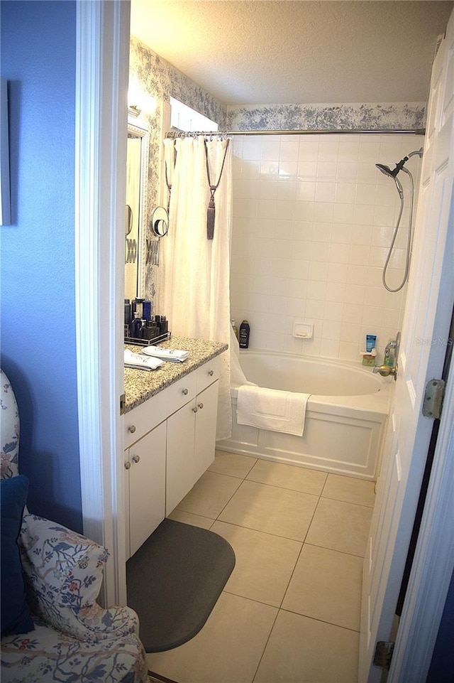 bathroom with vanity, shower / bathtub combination with curtain, tile patterned floors, and a textured ceiling