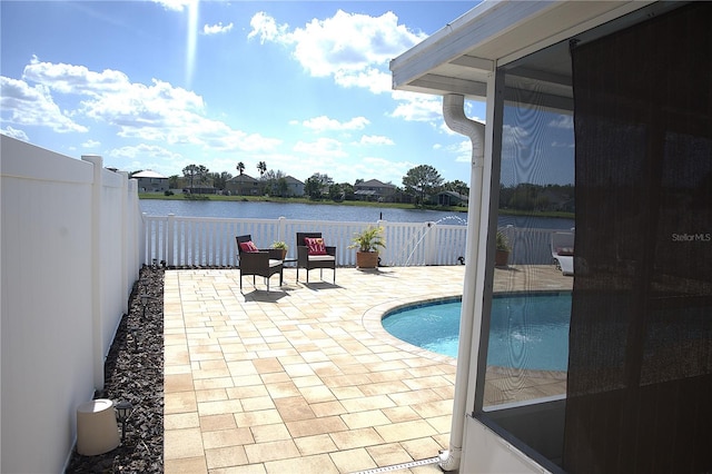 view of pool featuring a patio area and a water view