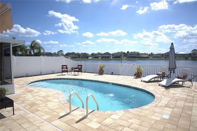 view of pool with a water view and a patio