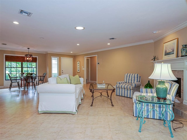 living room featuring ornamental molding and a tile fireplace