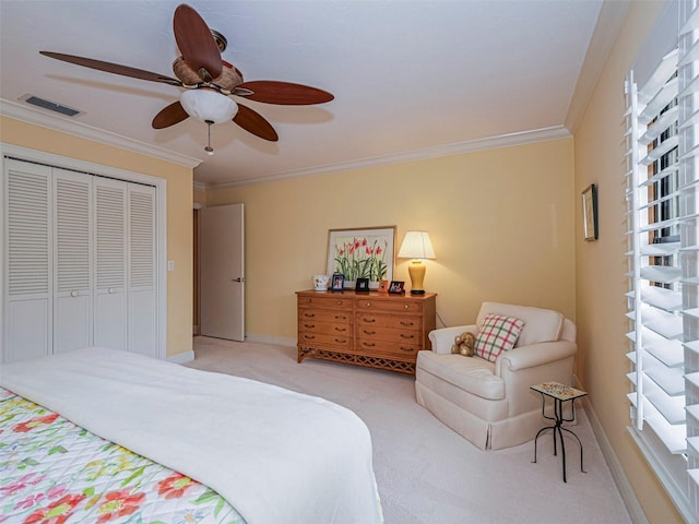 carpeted bedroom with crown molding, a closet, and ceiling fan