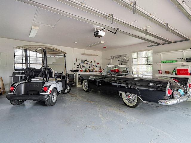 garage with a garage door opener and electric panel