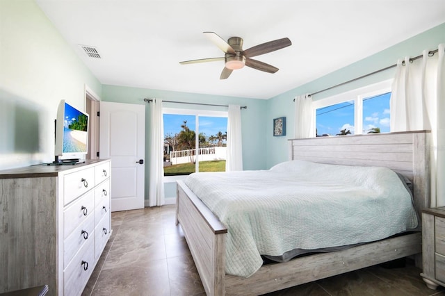 tiled bedroom featuring ceiling fan