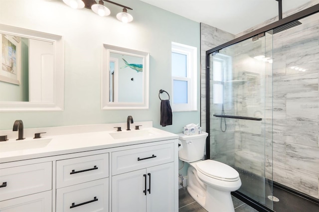 bathroom with vanity, a shower with shower door, toilet, and tile patterned floors