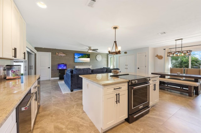 kitchen featuring white cabinets, black range with electric cooktop, light stone counters, and pendant lighting