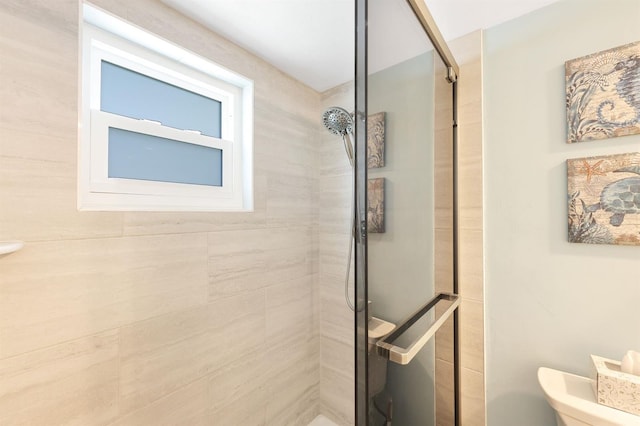 bathroom with toilet and walk in shower