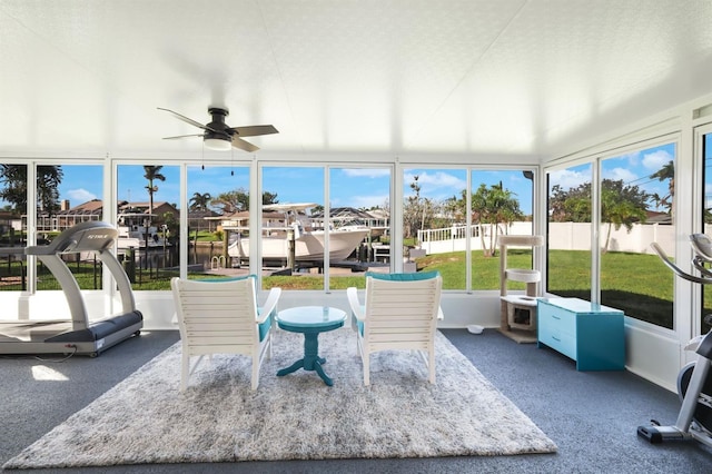 sunroom featuring ceiling fan