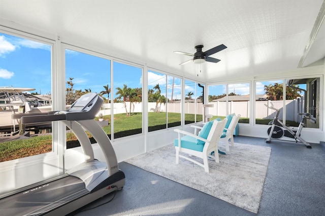 sunroom featuring ceiling fan and a healthy amount of sunlight