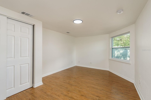 spare room featuring wood-type flooring