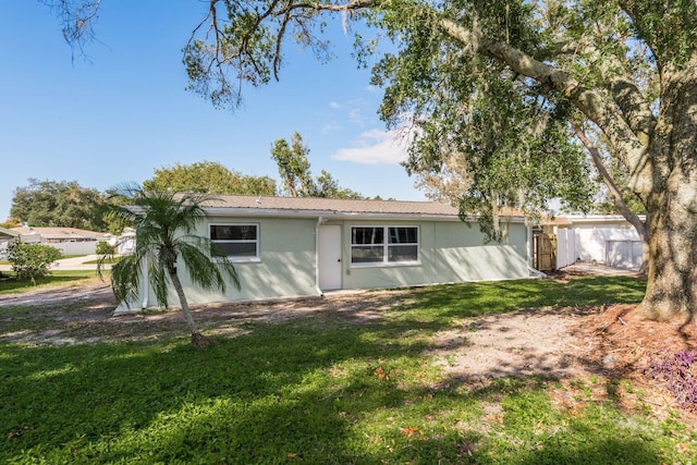 back of property featuring a lawn