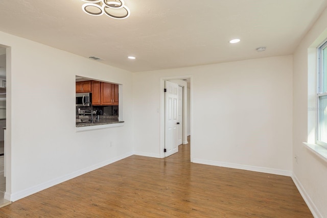 unfurnished living room with hardwood / wood-style flooring