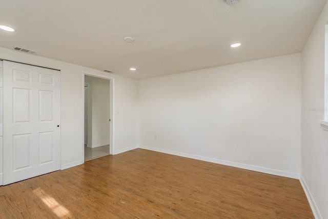 unfurnished bedroom with hardwood / wood-style floors and a closet