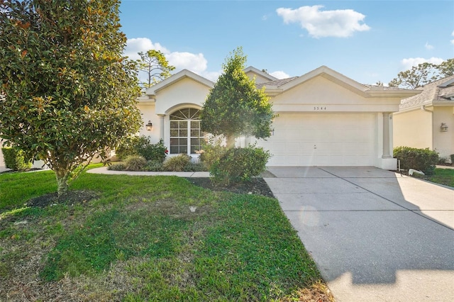 view of front of house with a garage and a front lawn