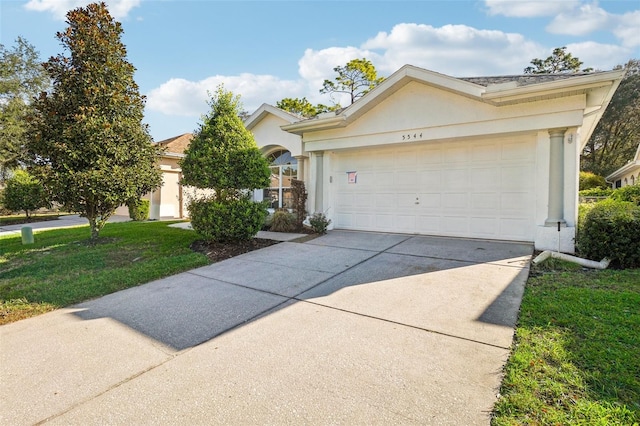 view of front of property with a front yard and a garage