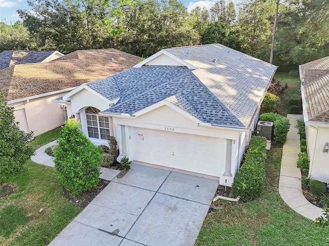 view of front of home featuring a garage and central air condition unit