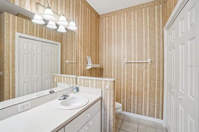 bathroom with vanity, toilet, a chandelier, and tile patterned flooring