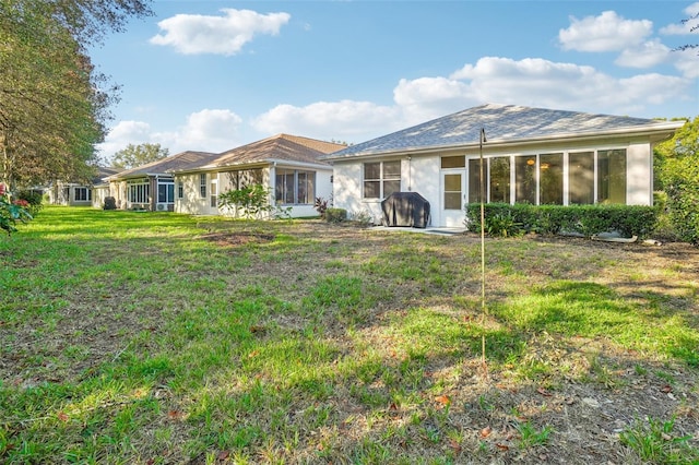 rear view of house with a yard