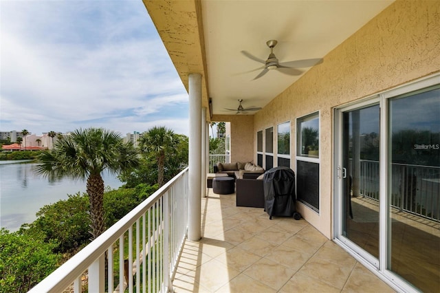 balcony with a water view, ceiling fan, and outdoor lounge area