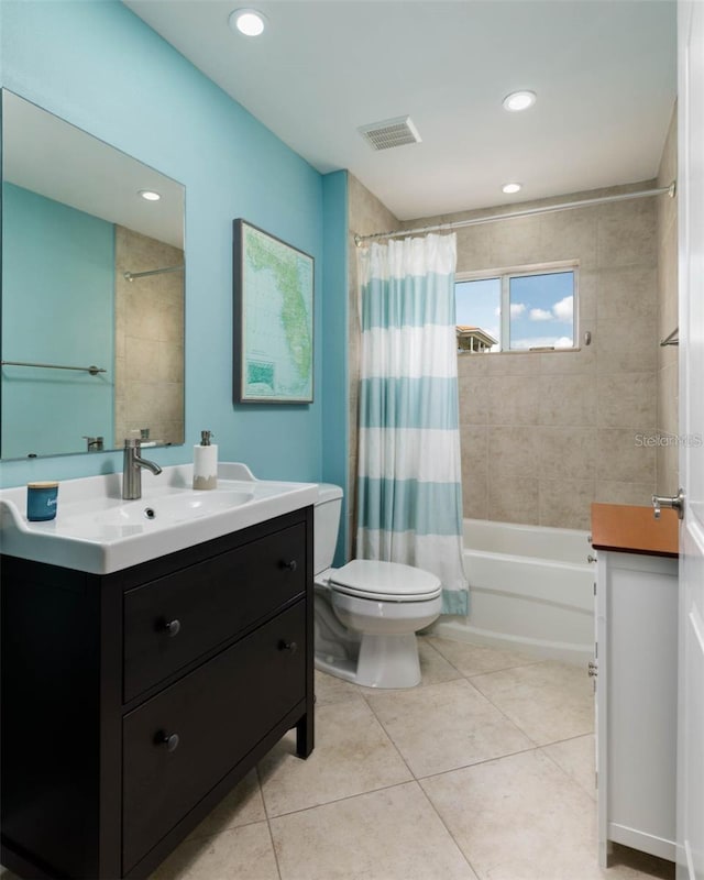 full bathroom featuring vanity, shower / bath combo with shower curtain, toilet, and tile patterned floors