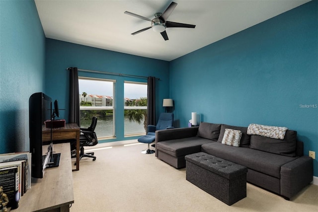 living room with ceiling fan and light colored carpet