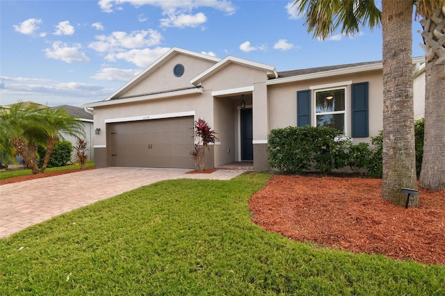 single story home with a garage and a front lawn