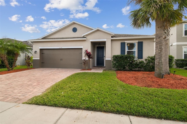 ranch-style home with a garage and a front lawn