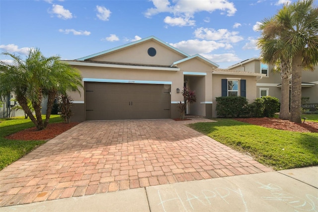 ranch-style home with a garage and a front lawn