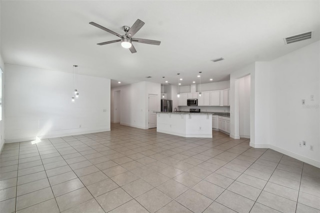 unfurnished living room featuring ceiling fan and light tile patterned floors