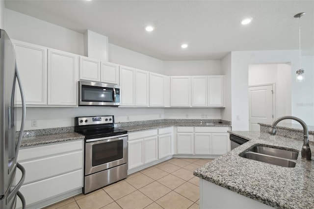 kitchen featuring white cabinets, sink, appliances with stainless steel finishes, light tile patterned flooring, and light stone counters