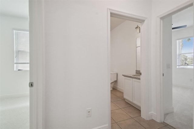 hall featuring light tile patterned floors